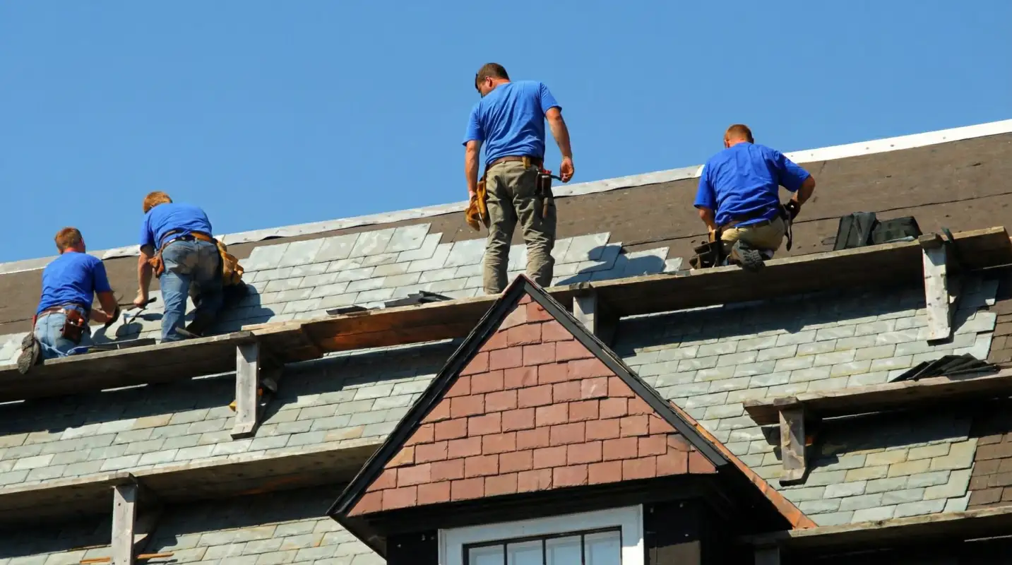 Roof replacement in progress with a team of professional contractors installing new shingles on a residential home in Boca Raton, FL